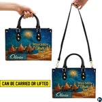 Side perspective view of three magi camel journey handbag and wallet pair