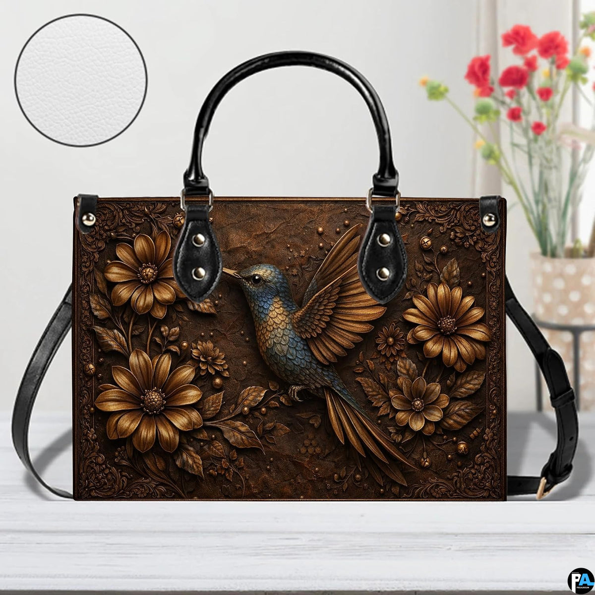 Side profile view of bronze floral handbag highlighting structured shape and generous proportions.