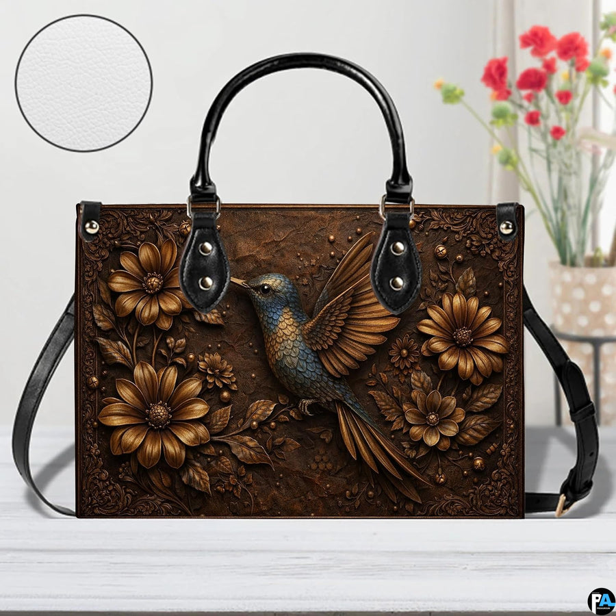 Side profile view of bronze floral handbag highlighting structured shape and generous proportions.