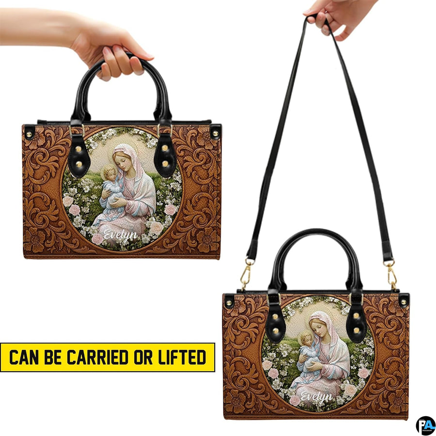 Side profile view of structured tooled Madonna handbag showing silhouette and black handles