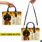 Display showcasing carrying versatility with dual top handles and shoulder styling.