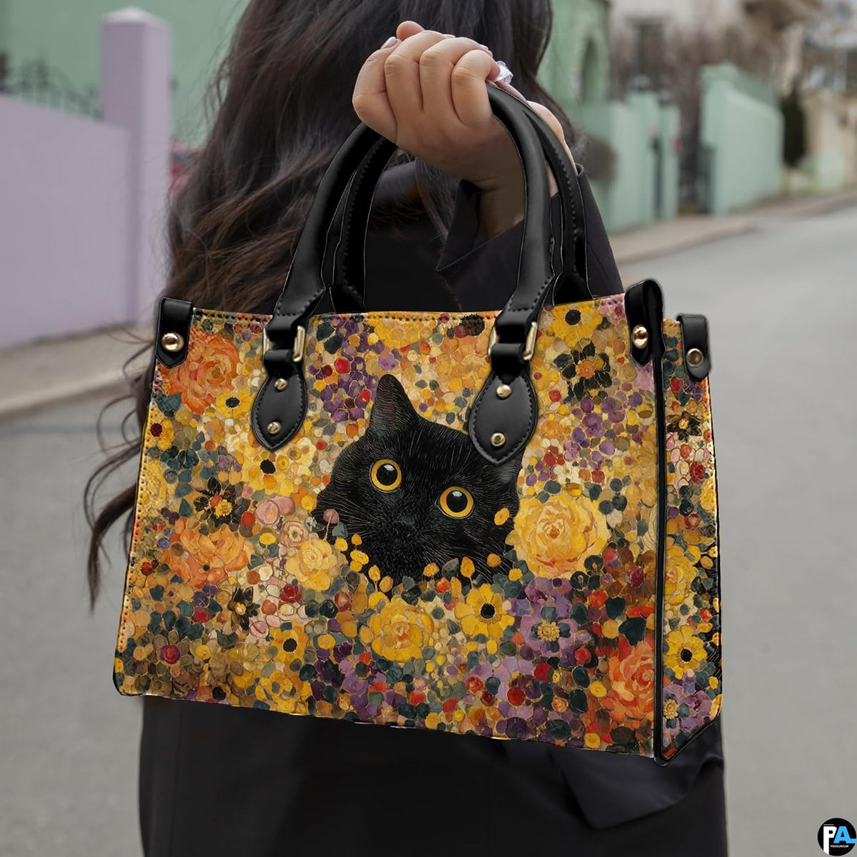 Model walking outdoors holding the black cat Gustav Klimt inspired floral printed creation.