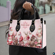 Model holding vintage Santa handbag outdoors by dual black top handles, displaying scale.