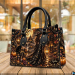 Gothic witch handbag and wallet displayed on wooden table beside potted plant.