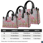 Back view of pink flamingo handbag showing coordinated floral detailing.
