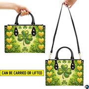 Multiple views of gold heart clover handbag with green four-leaf motif
