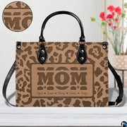 Direct frontal perspective highlighting tan leopard print rosettes and embossed central lettering.