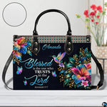 Hummingbird handbag on white table beside floral bouquet with texture swatch inset.