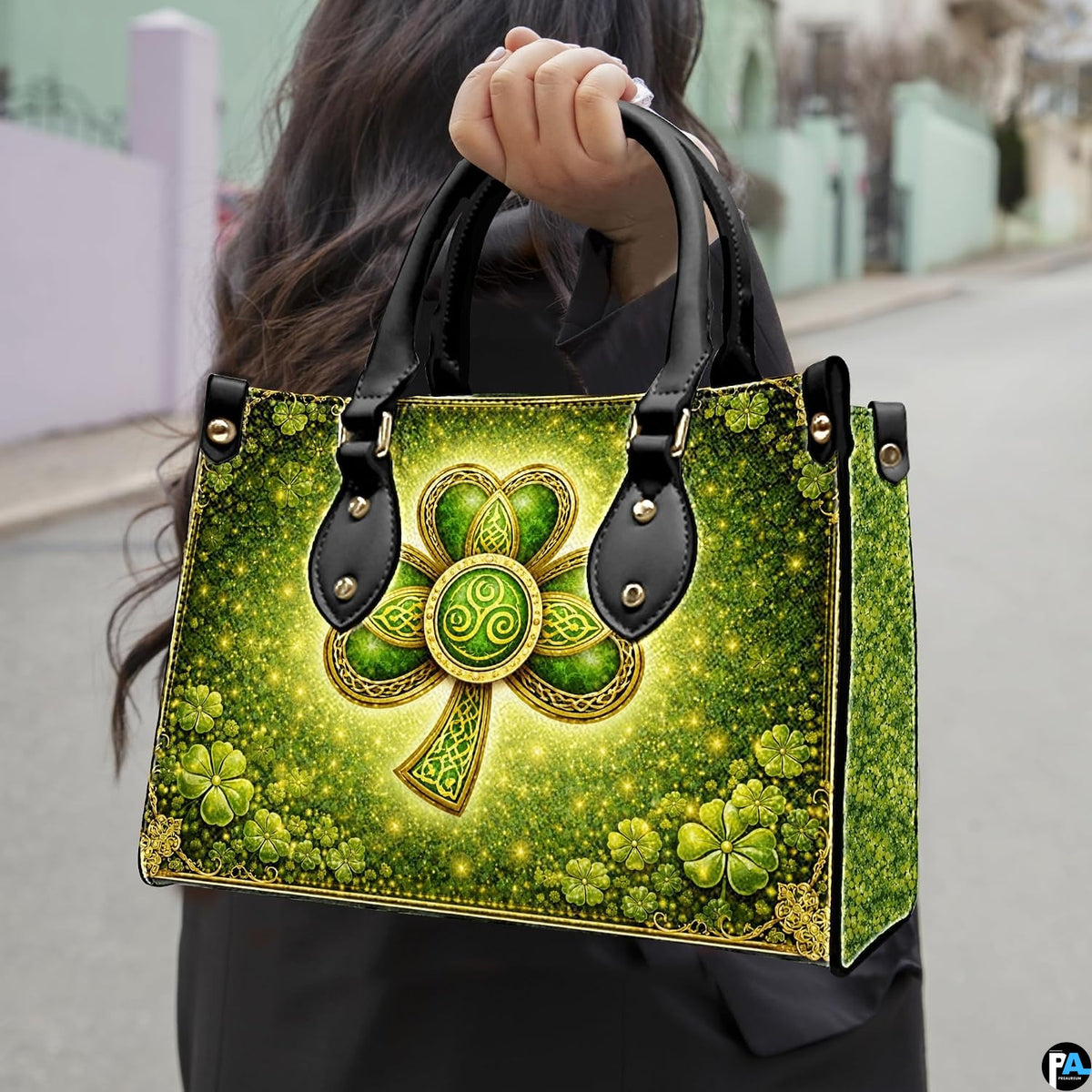 Model carrying shamrock handbag with gold Celtic knot details