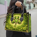 Model carrying shamrock handbag with gold Celtic knot details