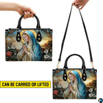 Model walking outdoors carrying stained glass Virgin Mary devotional handbag.