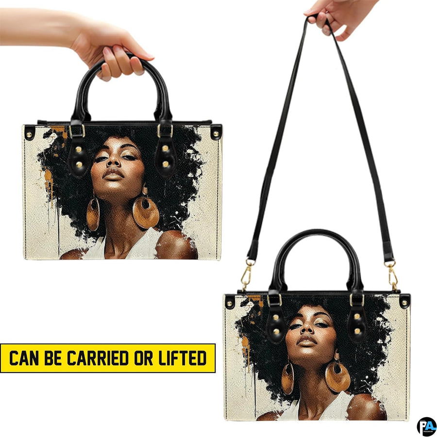Top-handle and shoulder views of cream and black afro woman portrait handbag