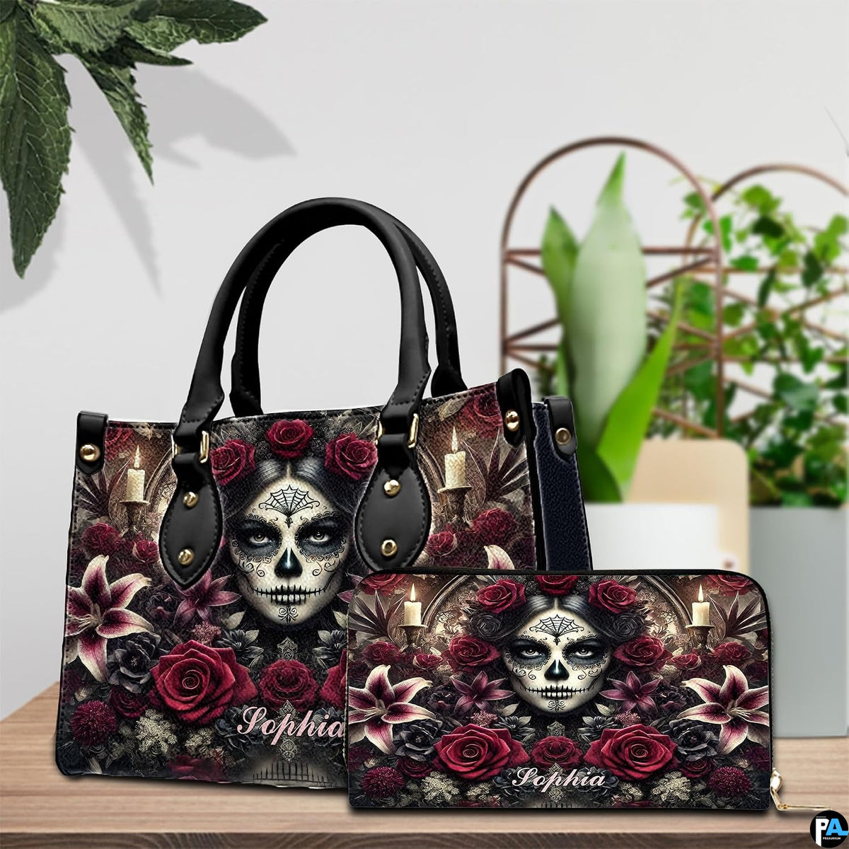 Sugar skull handbag and wallet on wooden table beside houseplant and wire trellis.