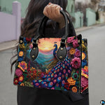 Woman carrying a vivid peacock handbag with flowers and mountain sunset artwork