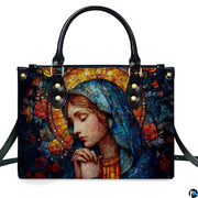 Front product view of turquoise veil praying Madonna handbag on white background.