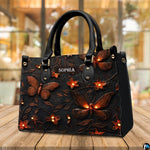 Luminous firefly handbag displayed on an outdoor wooden deck with bright cafe windows in view.