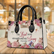 Scripture floral dragonfly handbag displayed on wooden tabletop in front of sunlit windows.