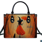 Autumn witch in orange gown with umbrella and black cat walking down golden tree path.