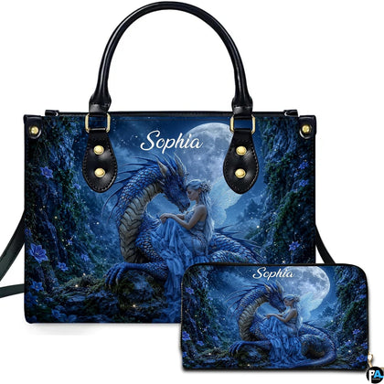 Moonlit blue dragon and winged fairy artwork displayed across top-handle handbag and matching companion wallet.