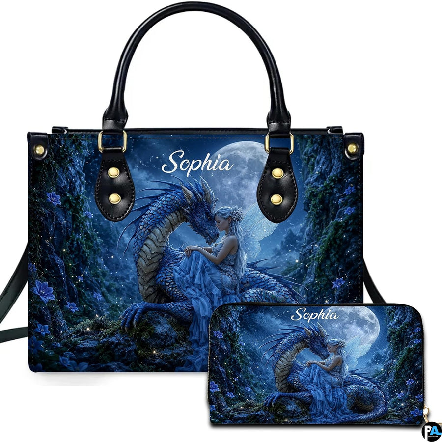 Moonlit blue dragon and winged fairy artwork displayed across top-handle handbag and matching companion wallet.