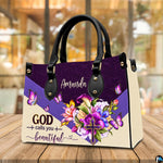 Floral butterfly handbag displayed on wooden tabletop in front of sunlit cafe window.