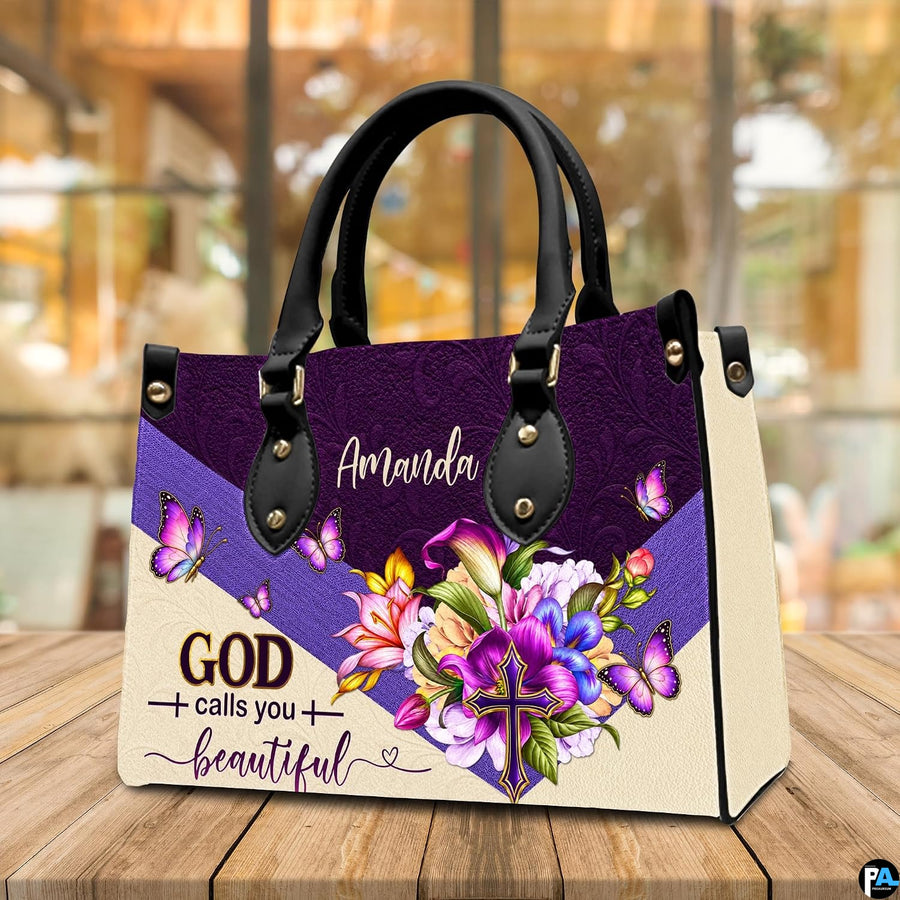 Floral butterfly handbag displayed on wooden tabletop in front of sunlit cafe window.