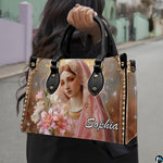Model carrying Virgin Mary and blooming lilies devotional handbag outdoors