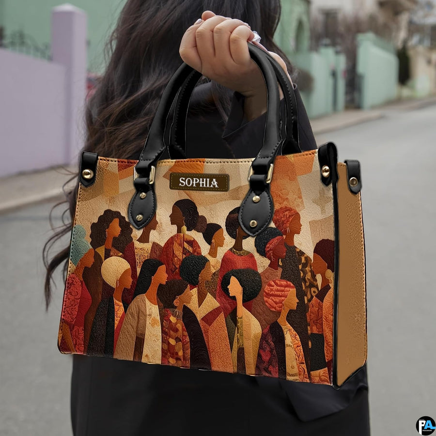 Diverse Black women community artwork showcased outdoors along a sunlit neighborhood pathway.