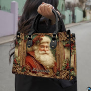 Outdoor lifestyle view of model carrying the vintage Santa portrait handbag.