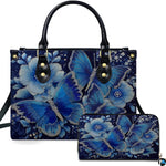 Sapphire butterfly handbag and matching zip wallet displayed against studio background with floral details.