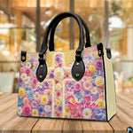 Floral cross handbag displayed on rustic wooden table in cafe setting.