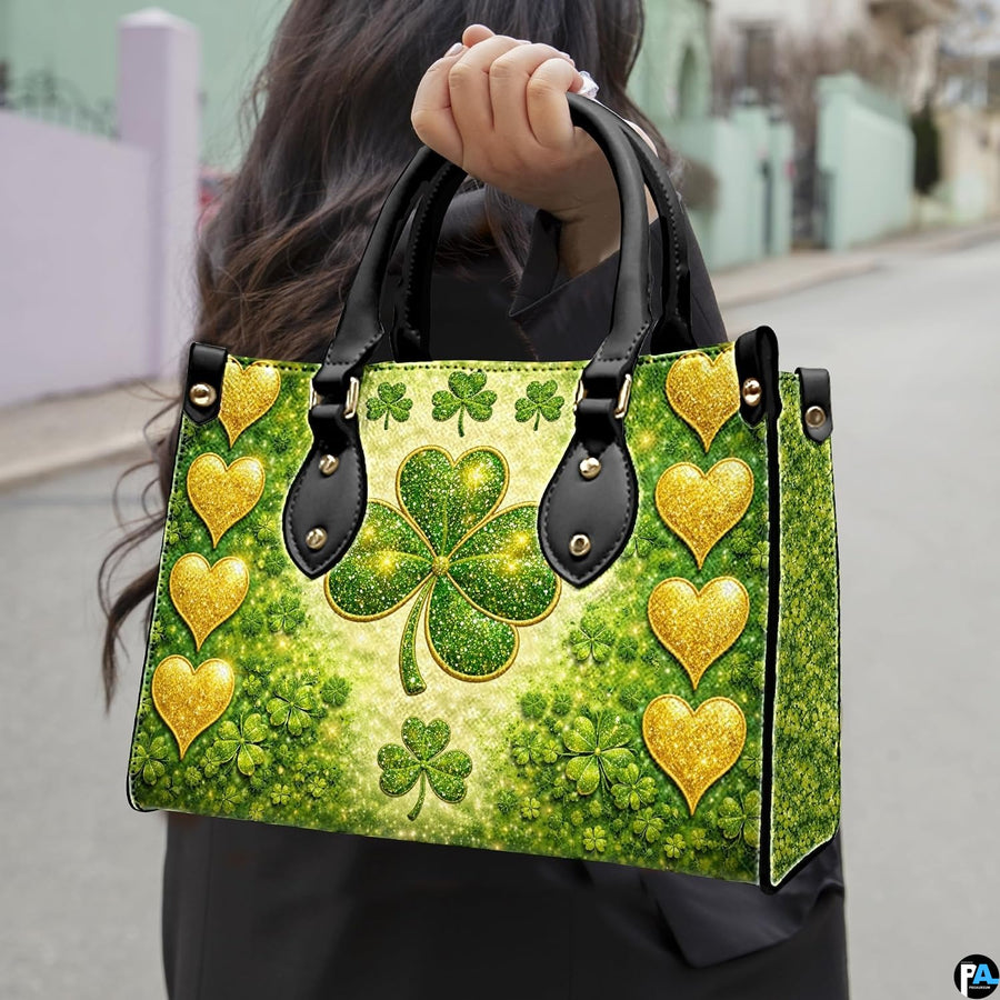 Model carrying gold heart clover handbag with glowing green artwork