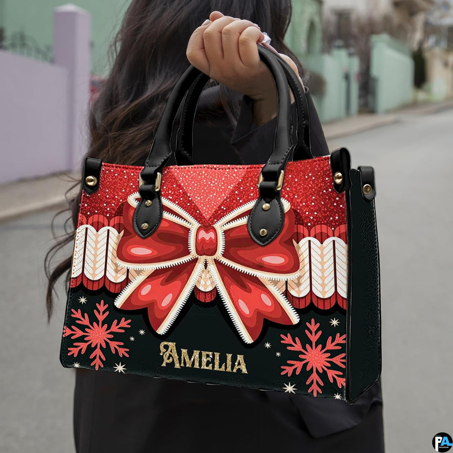 Christmas bow handbag displayed alongside matching wallet with red ribbon bow and snowflake motif.