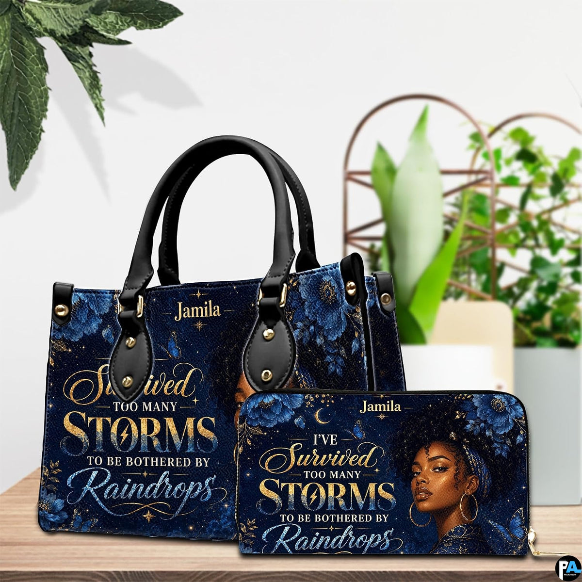 Tabletop presentation showing the celestial woman artwork and coordinating accessory near potted plants.