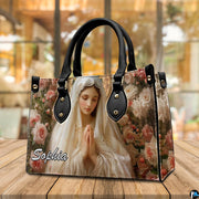 Devotional Virgin Mary rose art handbag displayed in a light-filled room setting