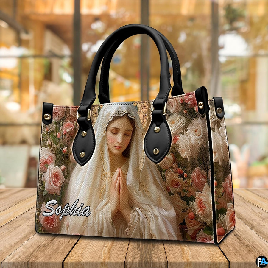 Devotional Virgin Mary rose art handbag displayed in a light-filled room setting