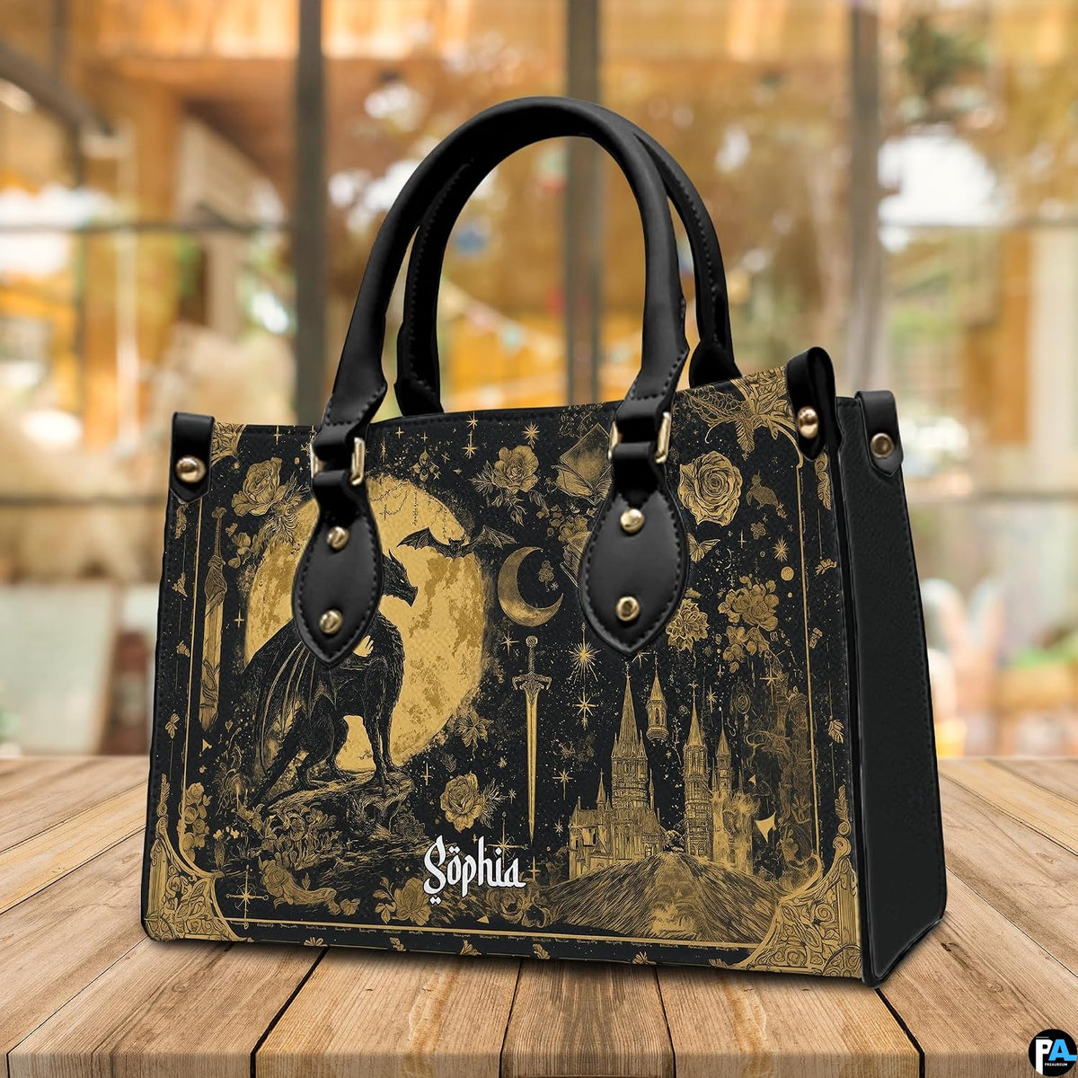 Golden dragon handbag and wallet displayed on wooden table before indoor plants.