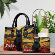 Tabletop presentation highlighting cat landscape art resting beside leafy indoor greenery.