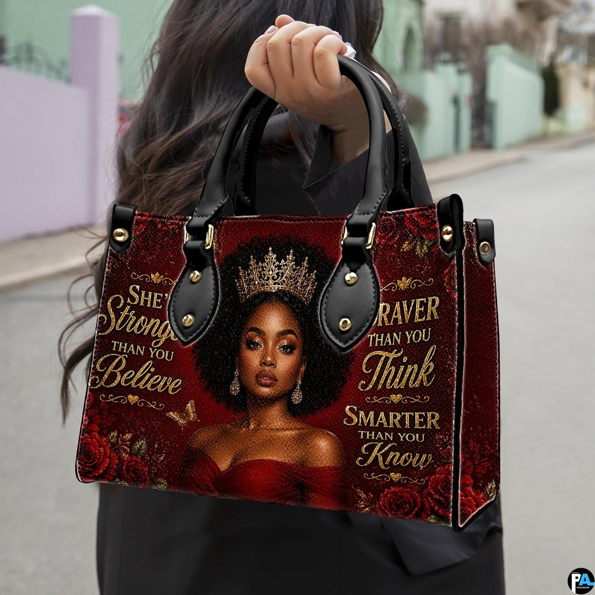 Outdoor presentation showing the ruby rose empress design held by pedestrian along sidewalk.