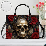 Golden skull handbag displayed on white table beside floral bouquet.