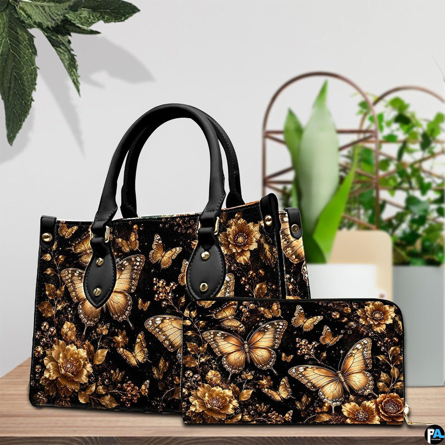 Tabletop view of gilded butterfly and floral artwork placed beside potted house plants in indoor setting.