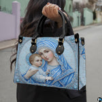 Angled view showing structured jeweled Madonna and Child sacred art handbag