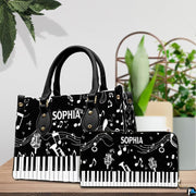 Pair showcase featuring monochrome musical artwork placed on wooden tabletop beside potted plant.