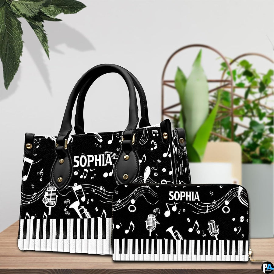 Pair showcase featuring monochrome musical artwork placed on wooden tabletop beside potted plant.