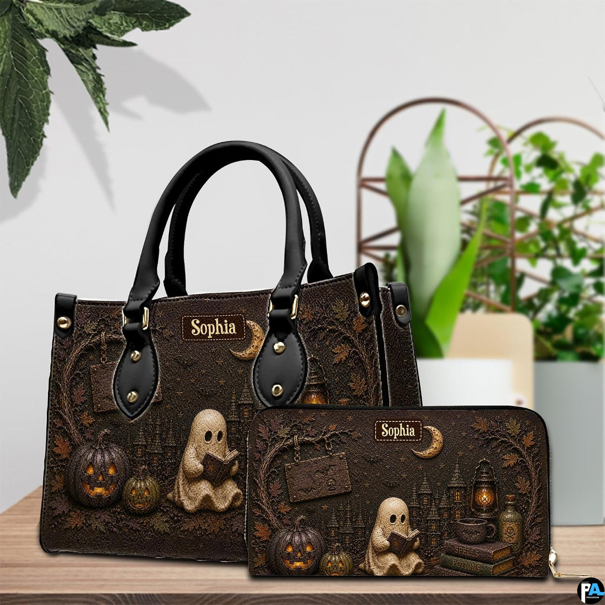 Pair showcase featuring gothic autumn artwork placed on wooden tabletop beside potted plant.