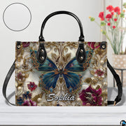 Close-up front view of matching zippered wallet showing baroque butterfly