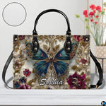 Close-up front view of matching zippered wallet showing baroque butterfly