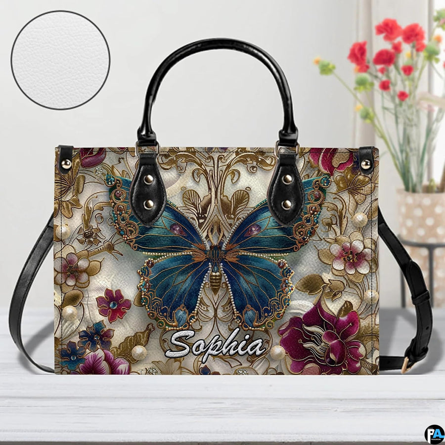 Close-up front view of matching zippered wallet showing baroque butterfly