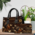 Angled brown portrait handbag with ornate headwrap, gold butterflies, and circular cross emblem