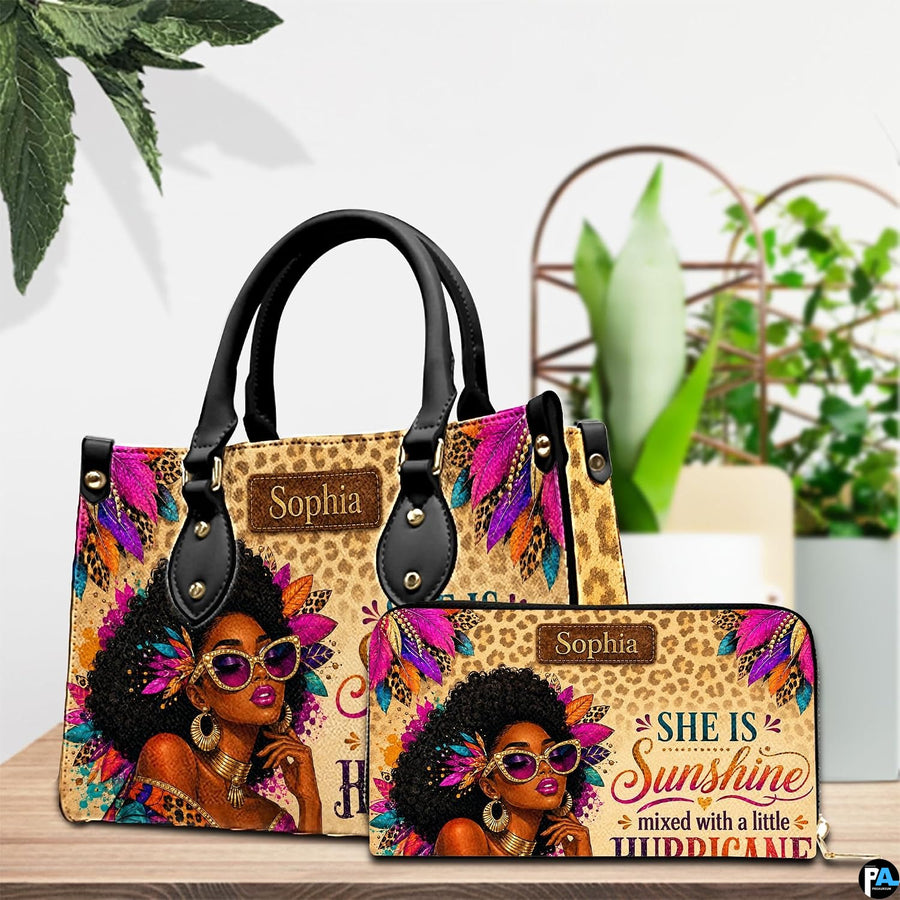 Tabletop presentation showing the feathered woman artwork and coordinating accessory near potted plants.
